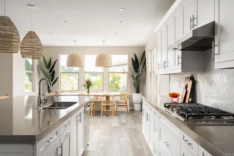 a kitchen with stainless steel appliances granite countertop a stove and a sink