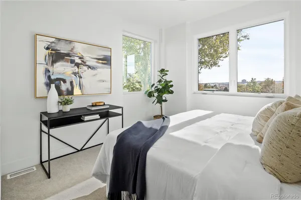 a bed sitting in a bedroom next to a window