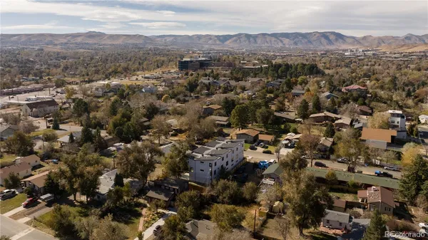 an aerial view of house with yard and mountain view