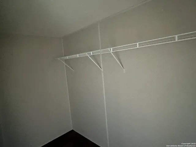 a bathroom with a granite countertop sink toilet and a mirror
