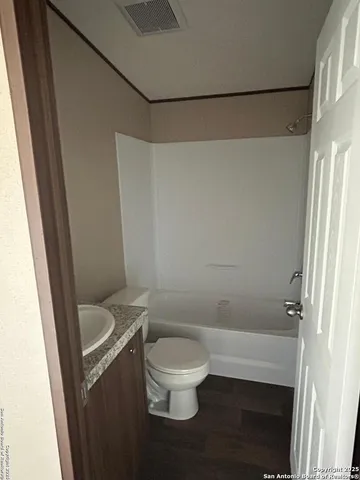 an empty room with wooden floor and a window