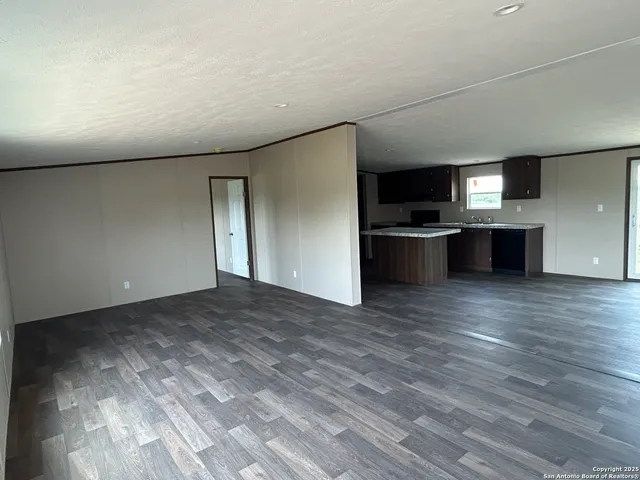 a large kitchen with a wooden floor and a stove top oven