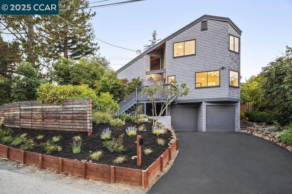 a front view of a house with plants