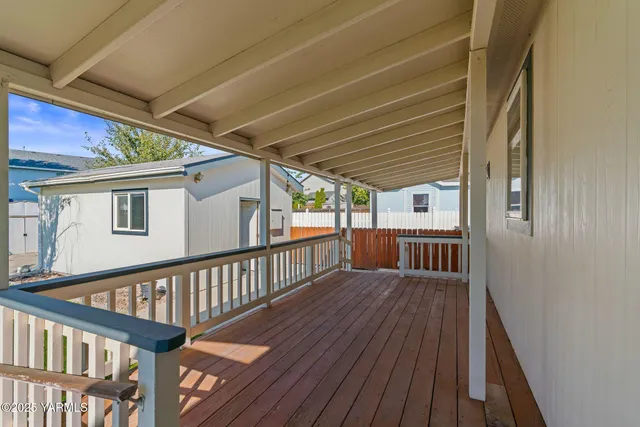 a view of a bedroom with a bed and wooden fence