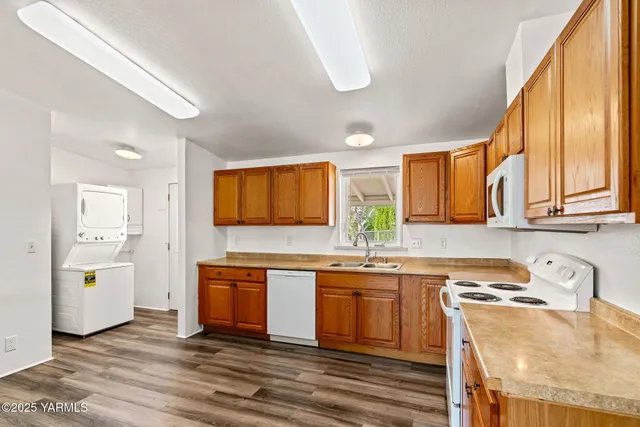 a kitchen with stainless steel appliances granite countertop a sink a stove and cabinets