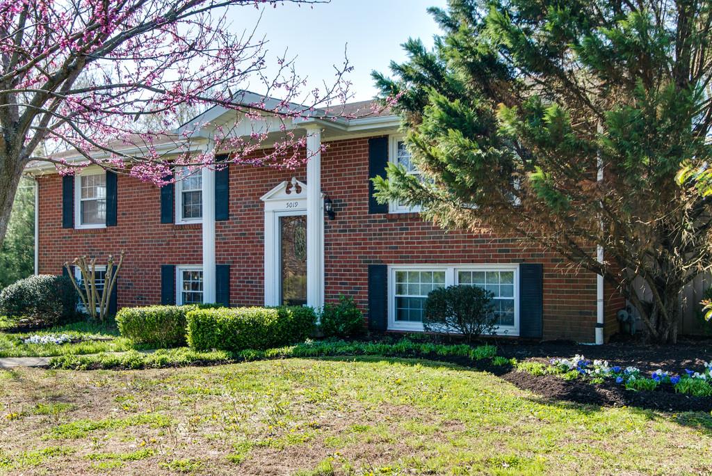 5019 Chaffin Drive Nashville, TN 37221 - Photo 1 of 30 a front view of a house with a yard and garage