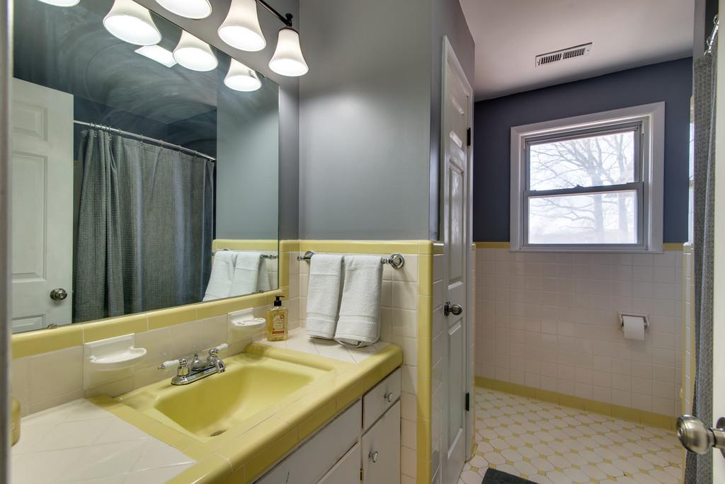 5019 Chaffin Drive Nashville, TN 37221 - Photo 14 of 30 a bathroom with a sink a mirror and a shower