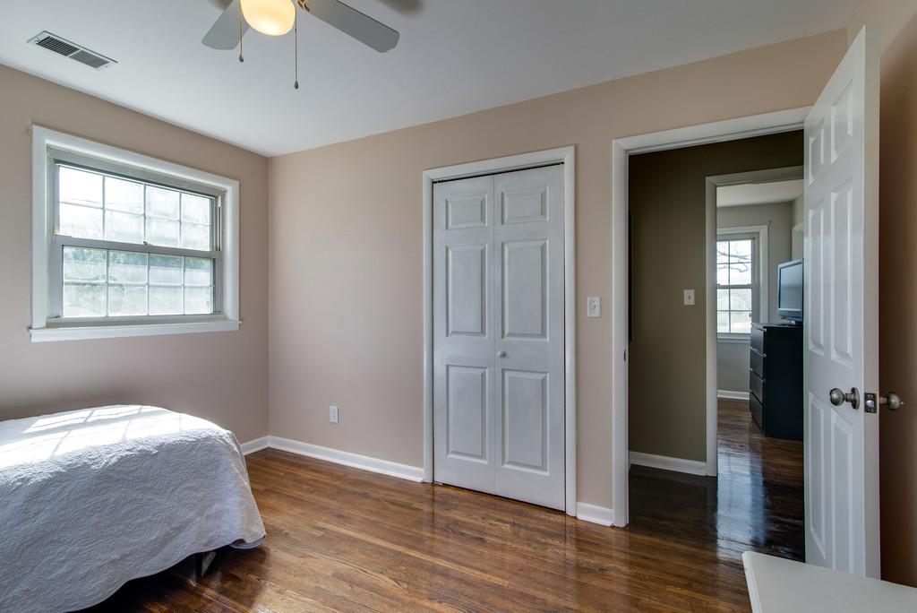 5019 Chaffin Drive Nashville, TN 37221 - Photo 16 of 30 a bedroom with a bed and wooden floor