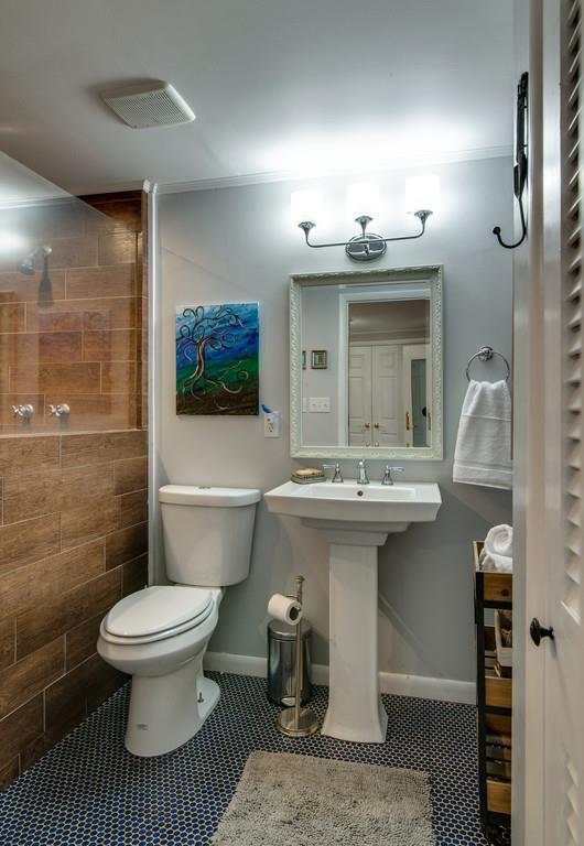 5019 Chaffin Drive Nashville, TN 37221 - Photo 22 of 30 a bathroom with a sink toilet and shower