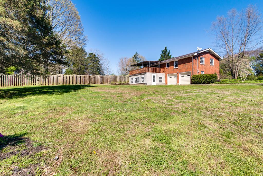 5019 Chaffin Drive Nashville, TN 37221 - Photo 28 of 30 a front view of a house with a yard and garage