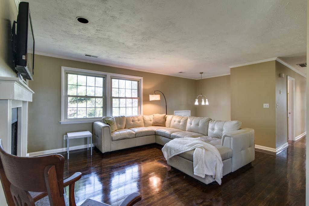 5019 Chaffin Drive Nashville, TN 37221 - Photo 4 of 30 a living room with furniture a flat screen tv and a large window