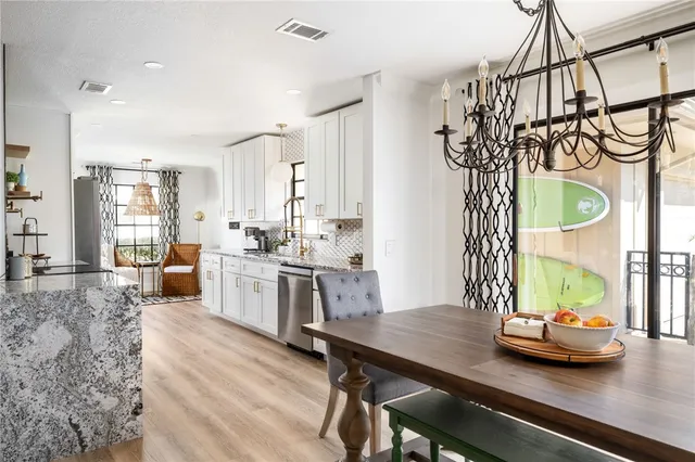 a kitchen with a table chairs stove and refrigerator