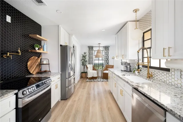 a large kitchen with a stove and a sink