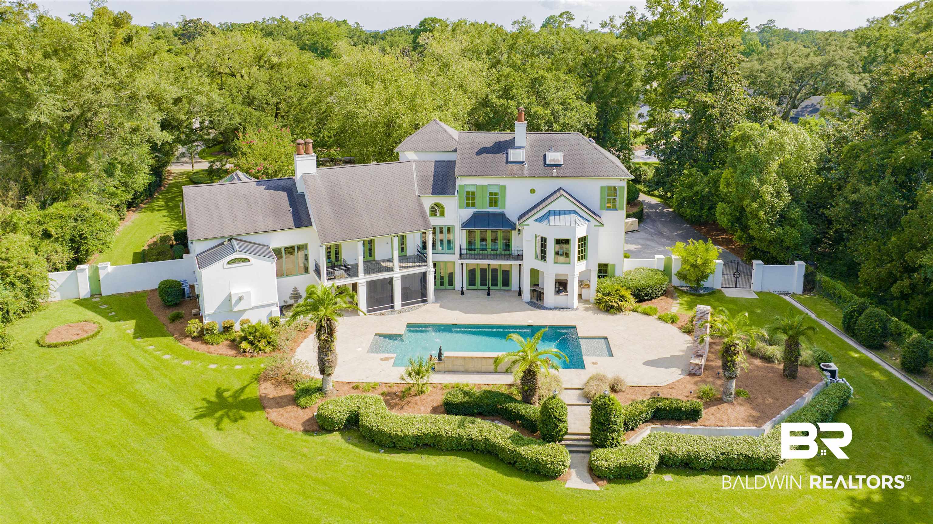 3816 Austill Lane Mobile, AL 36608 - Photo 2 of 80 Back of property featuring a fenced backyard, an outdoor pool, a chimney, and a jacuzzi