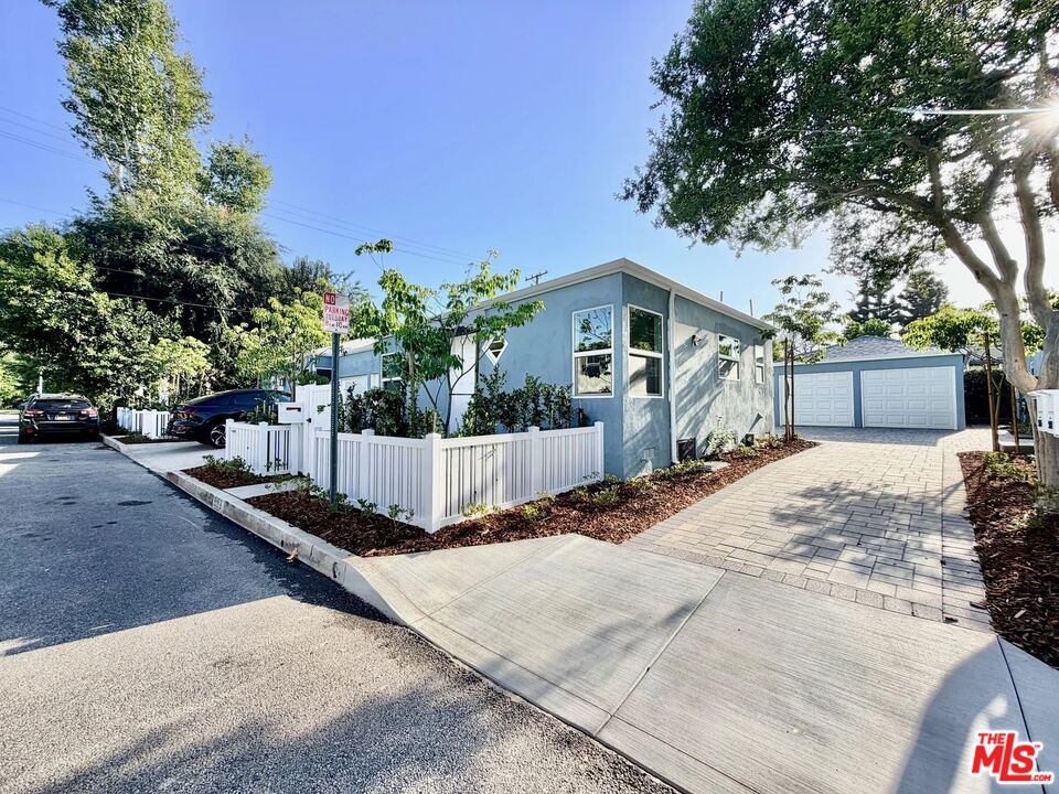 2924 West Riverside Drive Burbank, CA 91505 - Photo 12 of 15 a view of a white house with a yard and large tree
