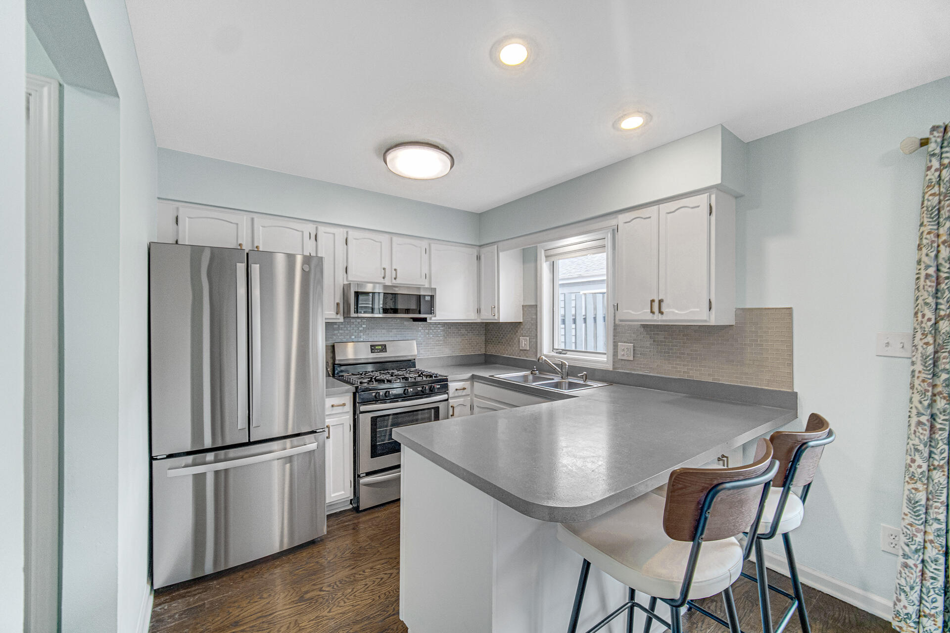771 Kenmare Parkway Crown Point, IN 46307 - Photo 11 of 19 a kitchen with stainless steel appliances granite countertop a refrigerator a stove a sink a stove a dining table and chairs with wooden floor