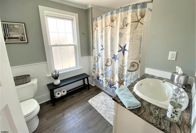 a spacious bathroom with a granite countertop tub sink and mirror