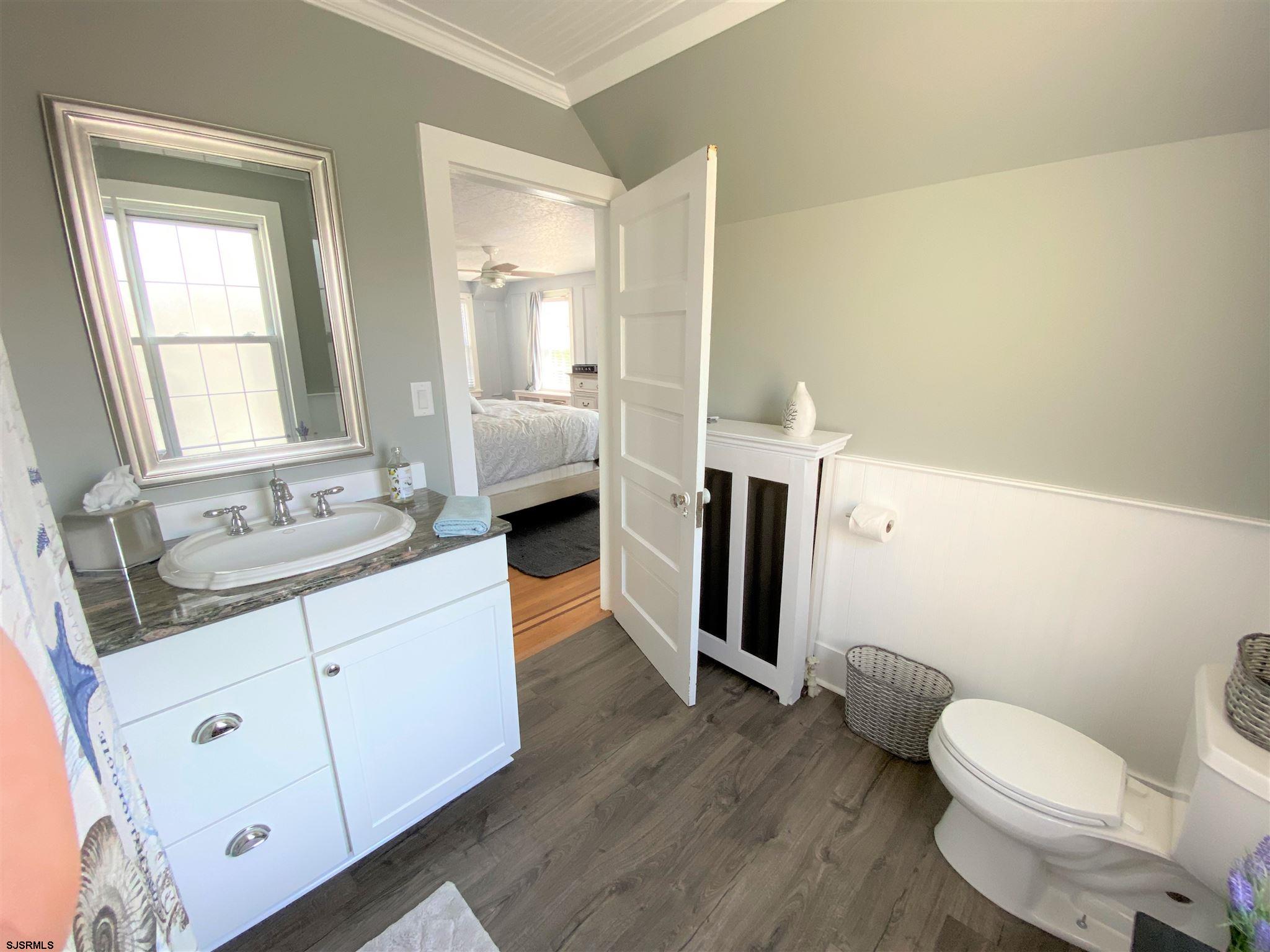 7207 Ventnor Avenue, Unit WINTER RENTAL Ventnor City, NJ 08406 - Photo 12 of 25 a bathroom with a granite countertop sink toilet and shower