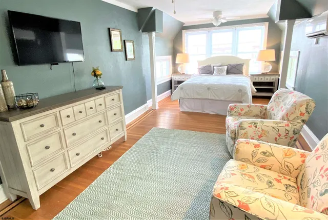 a living room with furniture cabinets and a flat screen tv