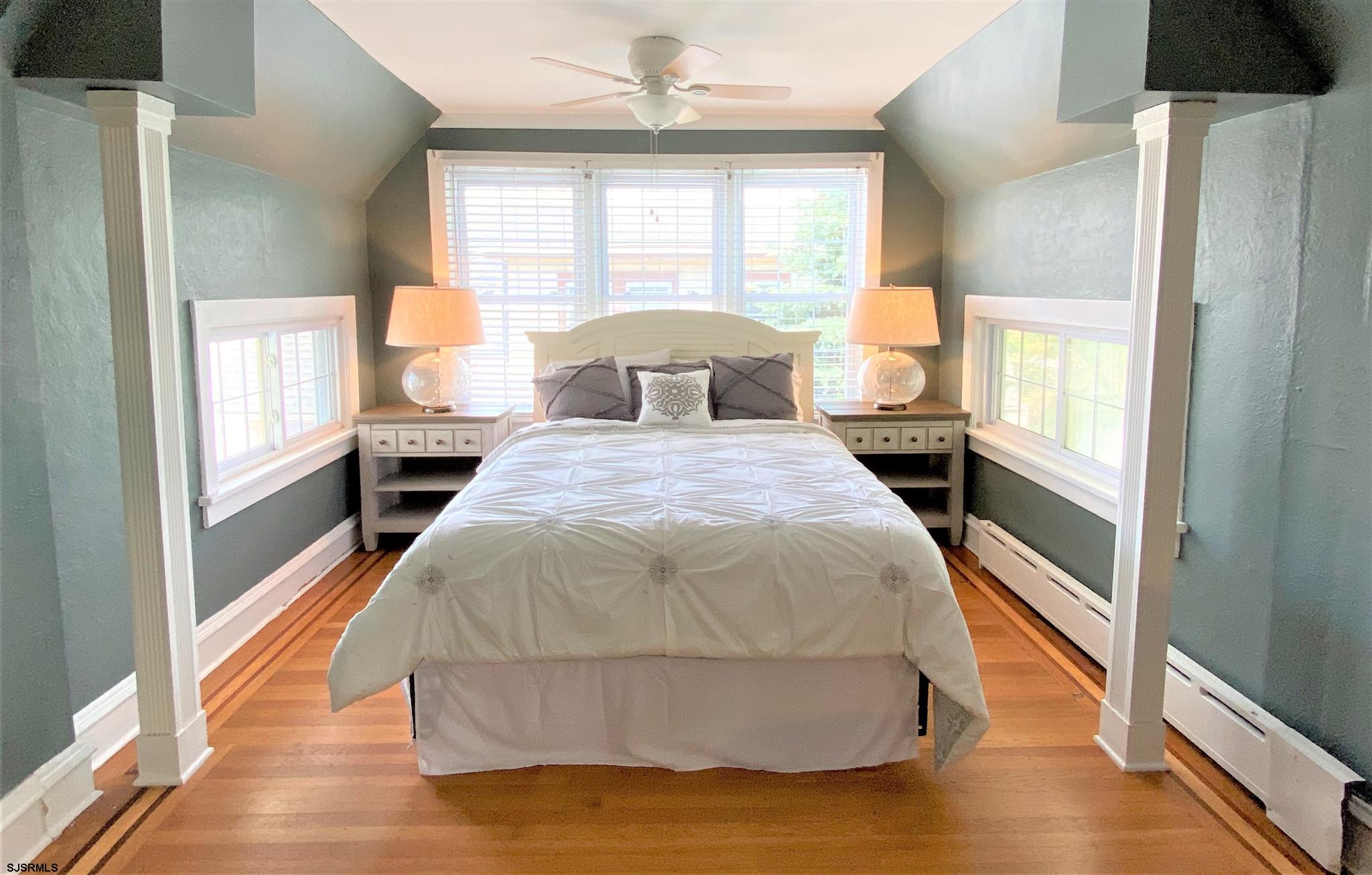 7207 Ventnor Avenue, Unit WINTER RENTAL Ventnor City, NJ 08406 - Photo 14 of 25 a spacious bedroom with a bed and a large window