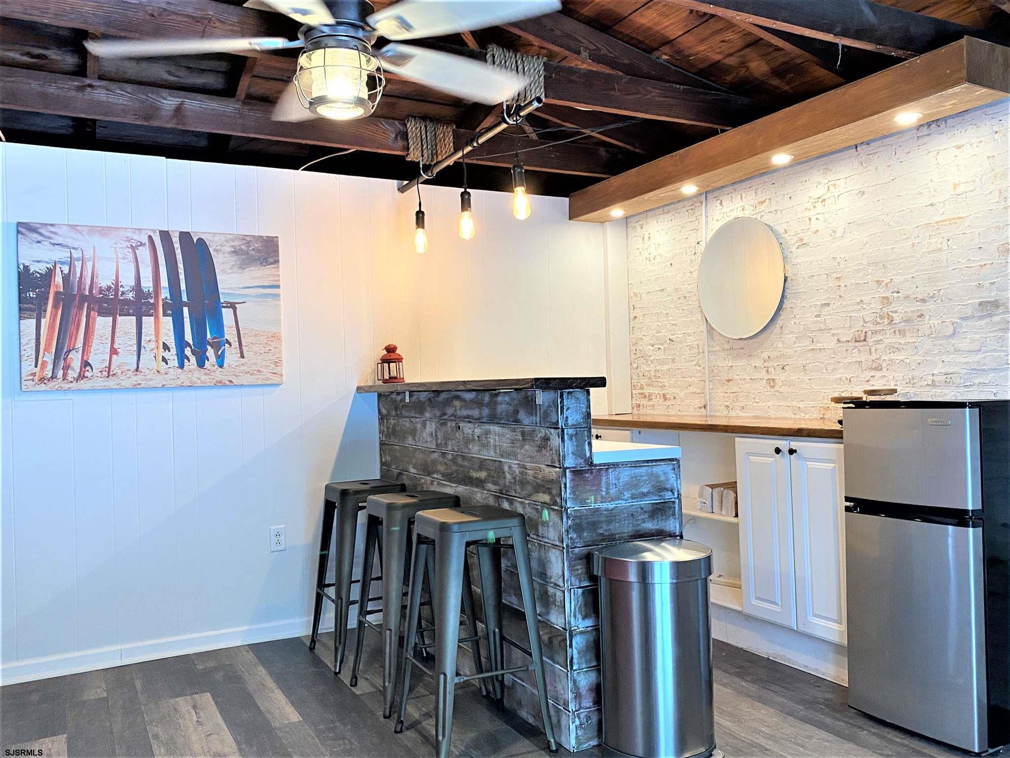 7207 Ventnor Avenue, Unit WINTER RENTAL Ventnor City, NJ 08406 - Photo 23 of 25 a bathroom with a granite countertop sink a mirror and vanity