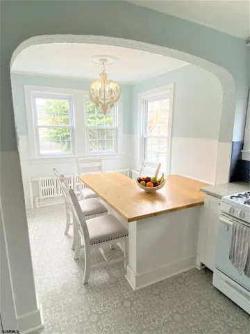 a dining room with a window table and chairs