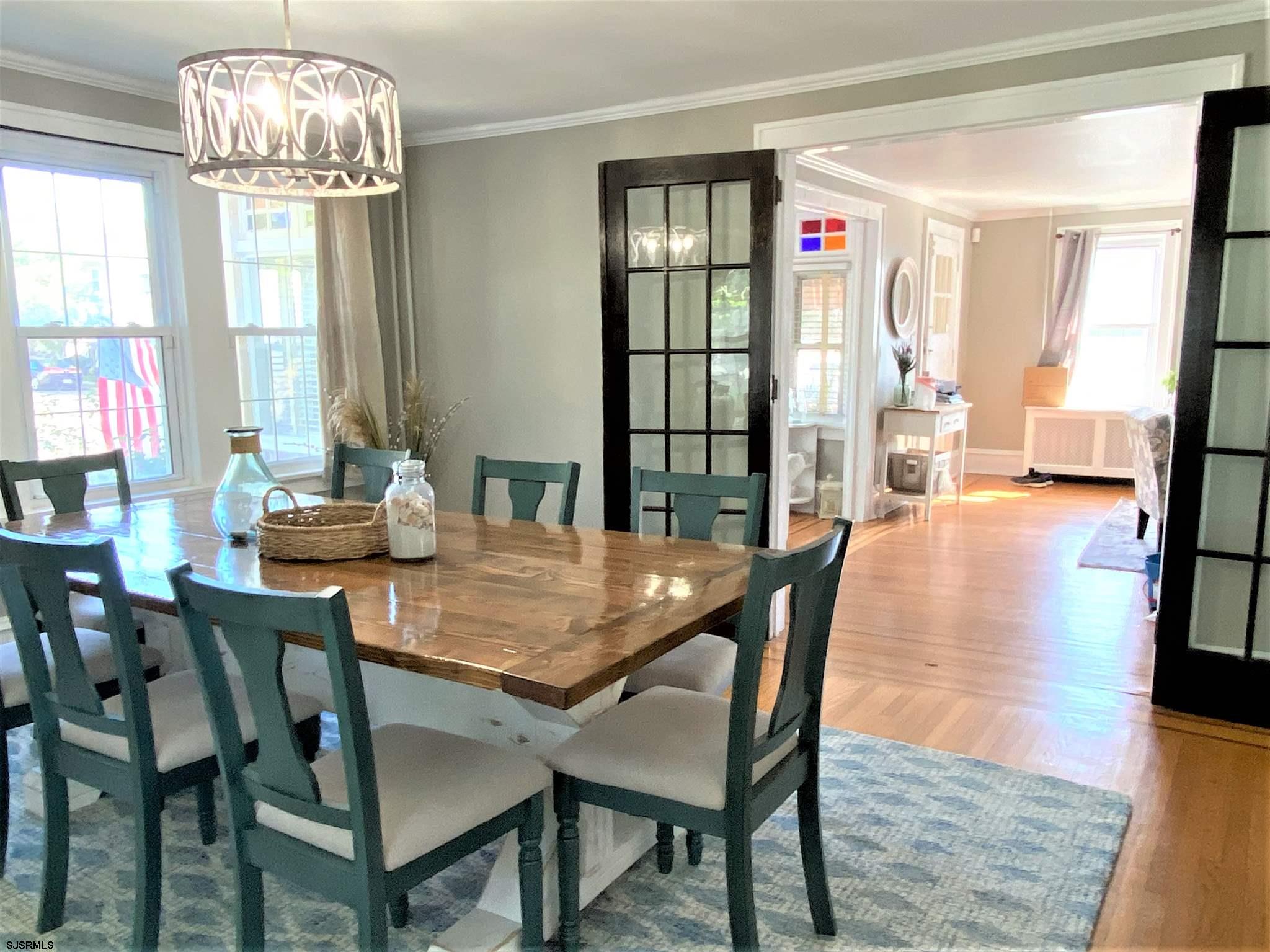 7207 Ventnor Avenue, Unit WINTER RENTAL Ventnor City, NJ 08406 - Photo 6 of 25 a dining room with furniture a chandelier and wooden floor