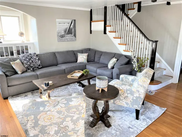 a living room with furniture a rug and a window