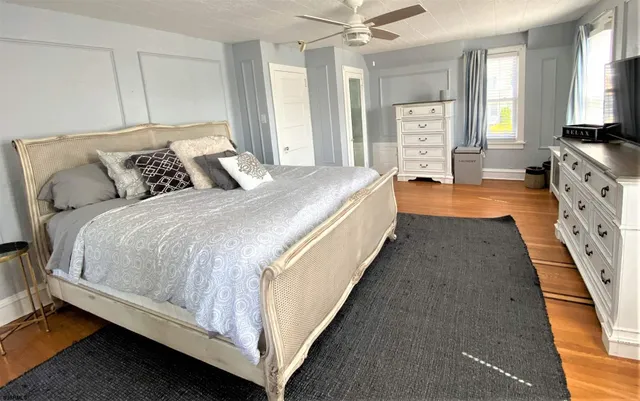 a spacious bedroom with bed and a chandelier