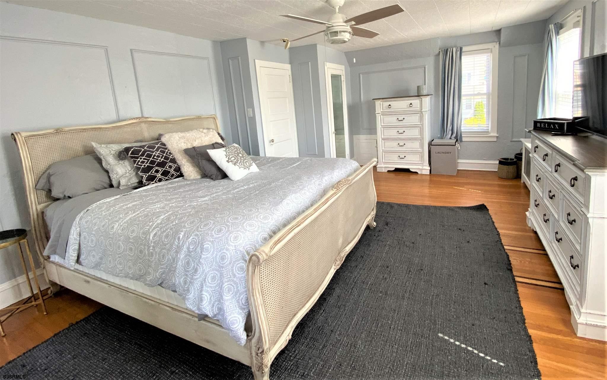 7207 Ventnor Avenue, Unit WINTER RENTAL Ventnor City, NJ 08406 - Photo 10 of 25 a spacious bedroom with bed and a chandelier