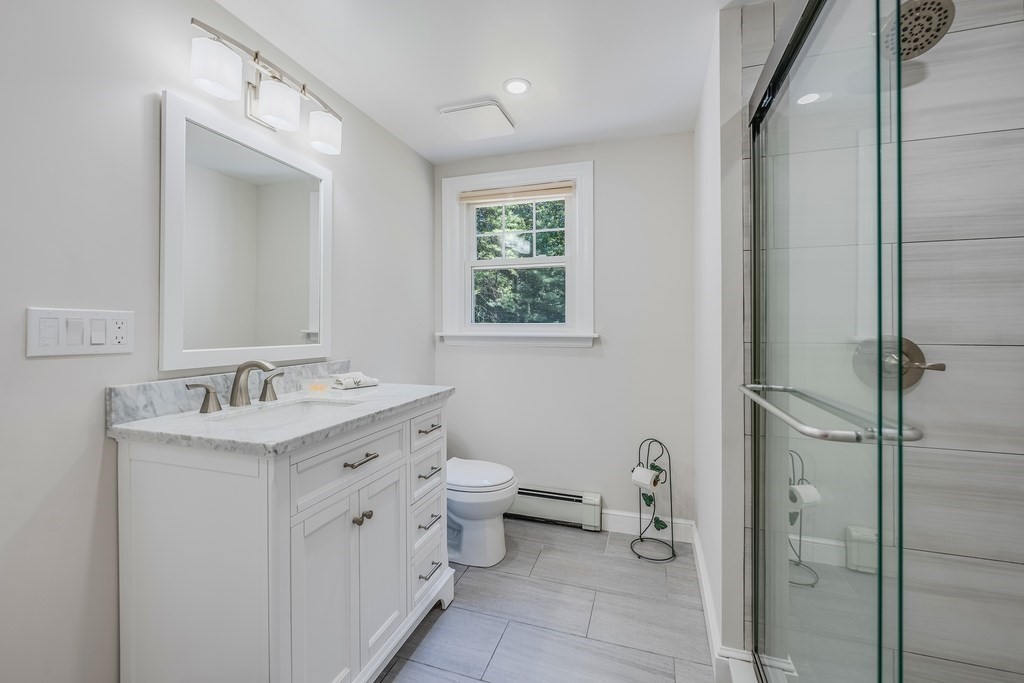 21 Cutler Drive Ashland, MA 01721 - Photo 12 of 28 a bathroom with a granite countertop sink toilet and shower