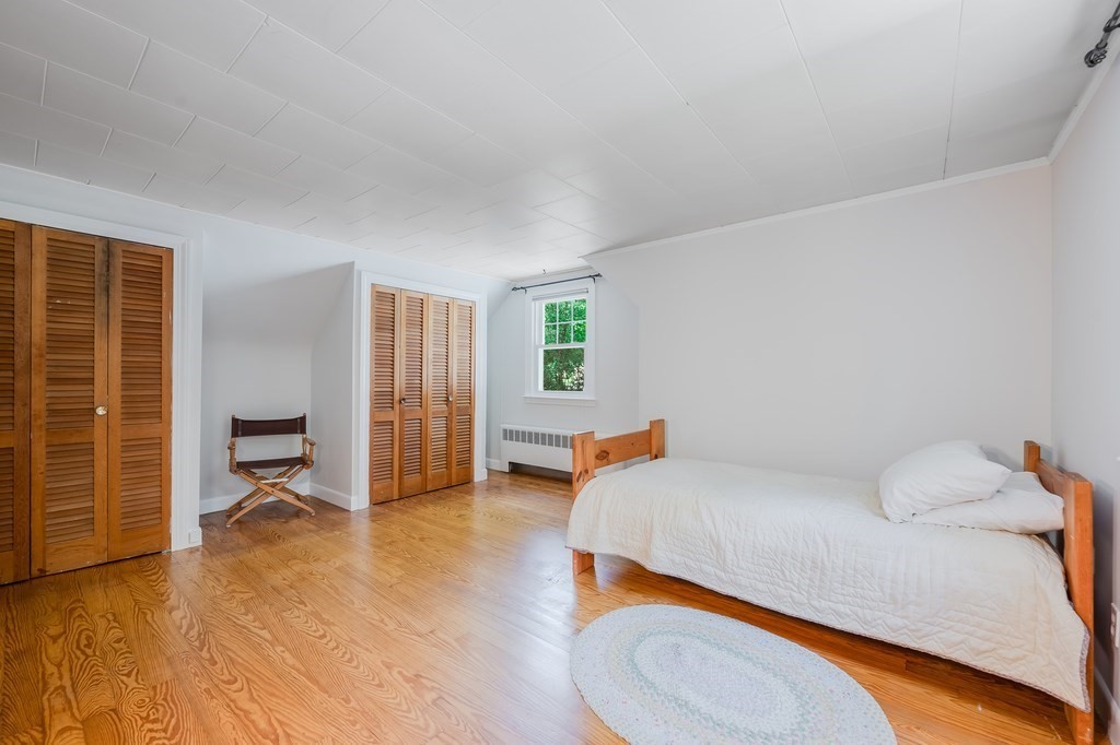 21 Cutler Drive Ashland, MA 01721 - Photo 21 of 28 a bedroom with a bed and wooden floor
