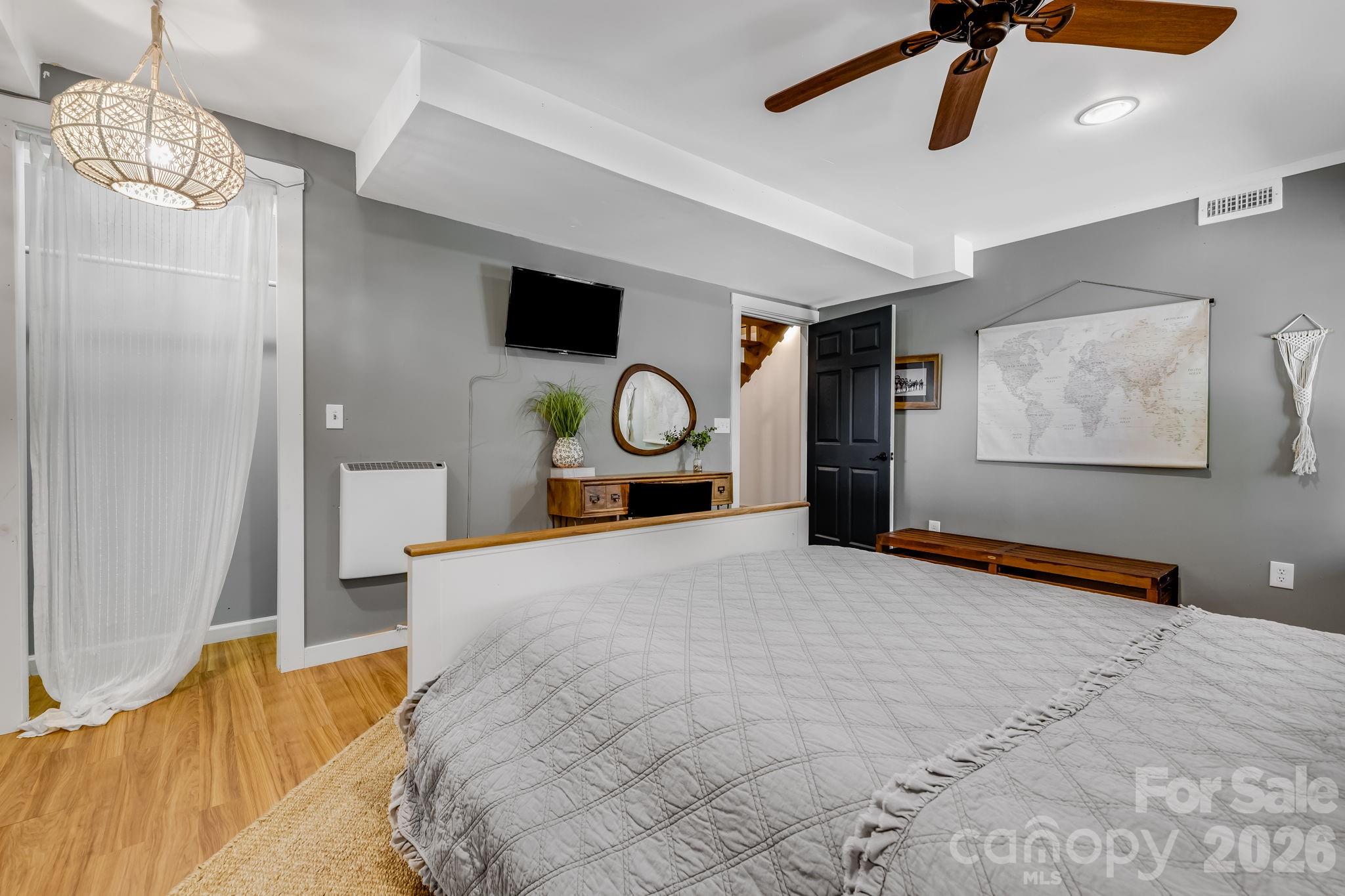 694 Boulder Road Marshall, NC 28753 - Photo 34 of 44 a bedroom with a bed and a chandelier