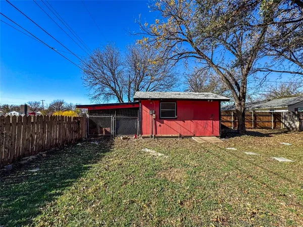 a view of a house with red door and tree