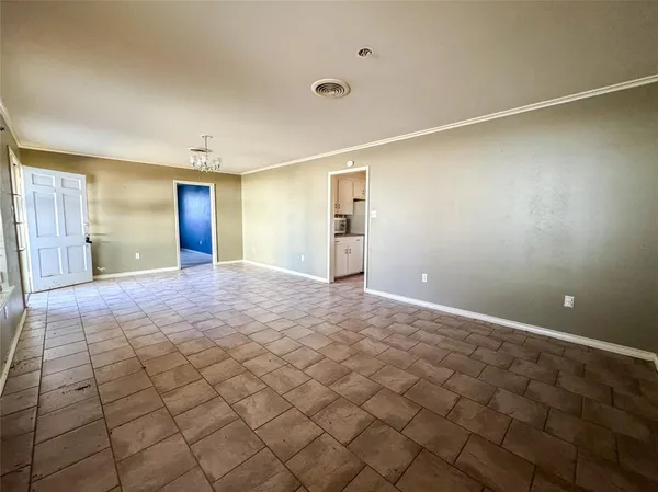 a view of a livingroom with an empty space and a window