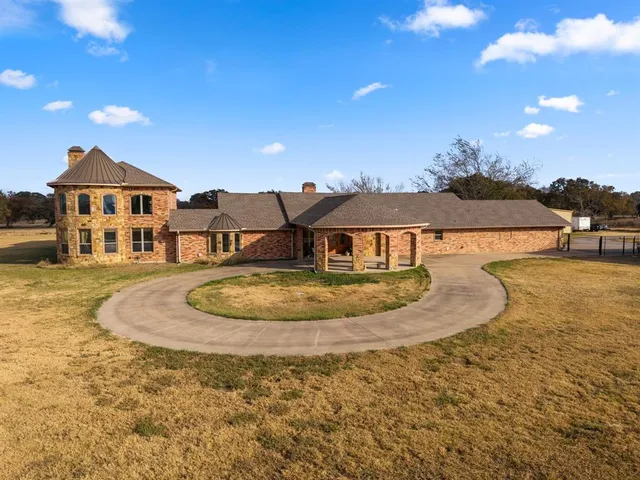 a view of a white house with a swimming pool and a yard