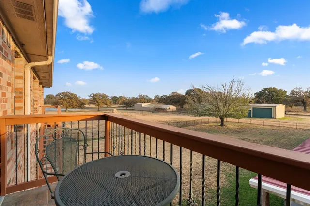 a view of a balcony with chair and wooden fence