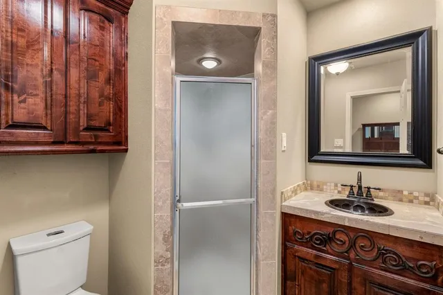 a bathroom with a sink a toilet and mirror