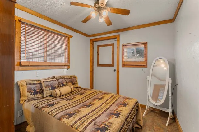 a bedroom with a bed a dresser and chair