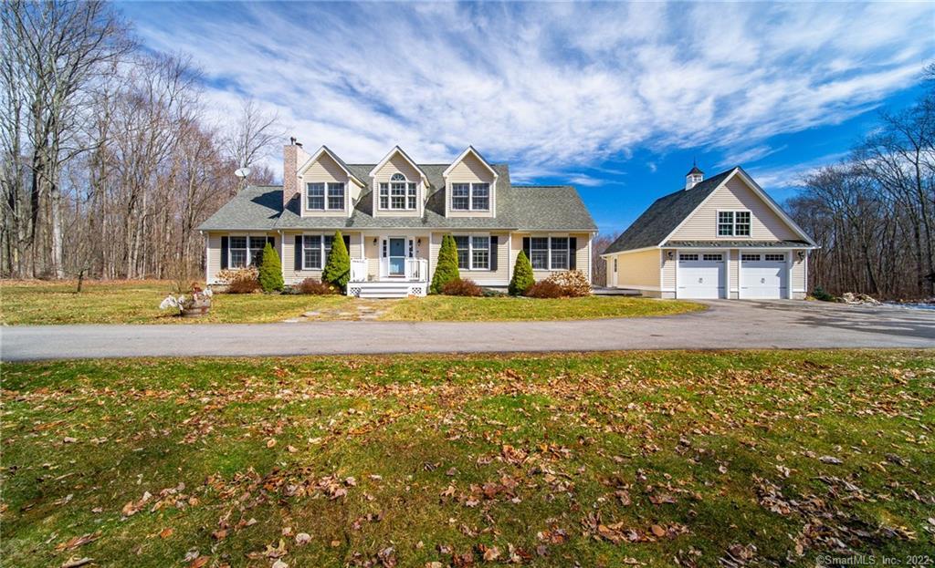 92 Quarry Hill Road Haddam, CT 06424 - Photo 1 of 1 a front view of a house with a yard table and chairs