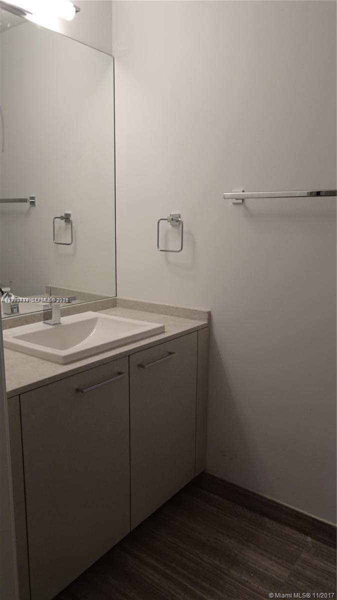 1010 Brickell Avenue, Unit 3211 Miami, FL 33131 - Photo 8 of 11 a bathroom with a sink and vanity