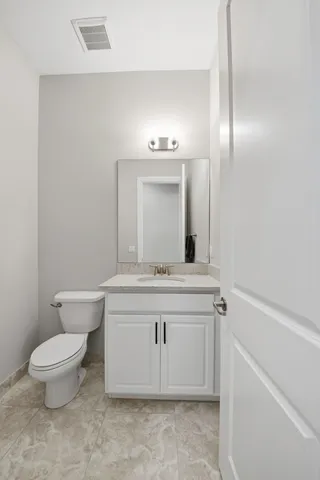 a bedroom with a large bed a flat tv screen and dresser