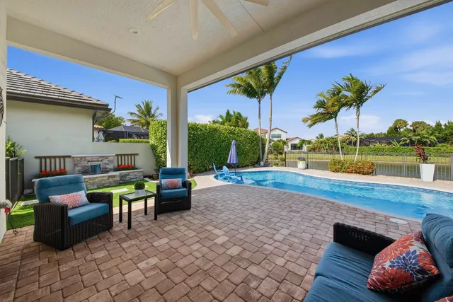 a view of a swimming pool with a lounge chair and a fire pit