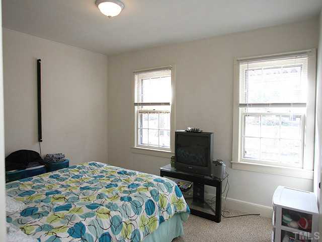 3810 Bland Road Raleigh, NC 27609 - Photo 8 of 12 a bedroom that has a bed and a chair in it