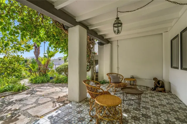a dining room with furniture a potted plant and a rug