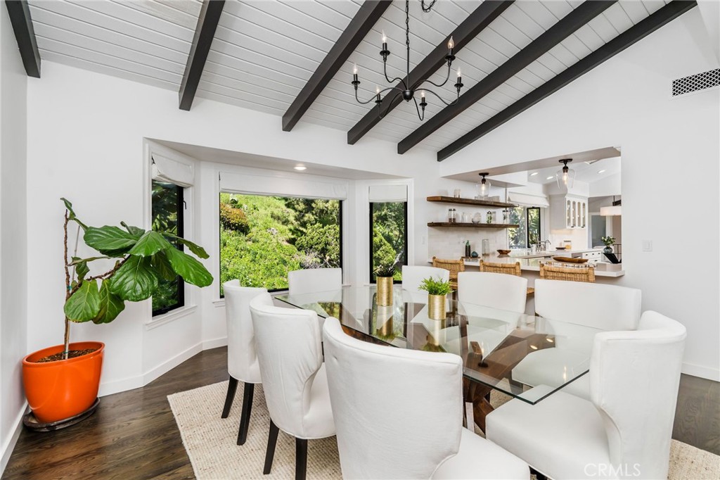 24743 Vantage Point Terrace Malibu, CA 90265 - Photo 15 of 64 a dining room with furniture a potted plant and a rug