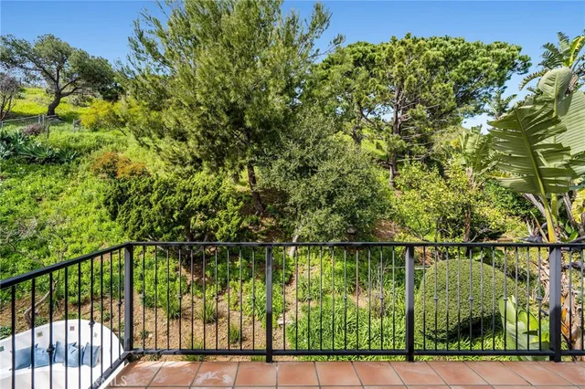 a bedroom with a bed a flat screen tv and a window