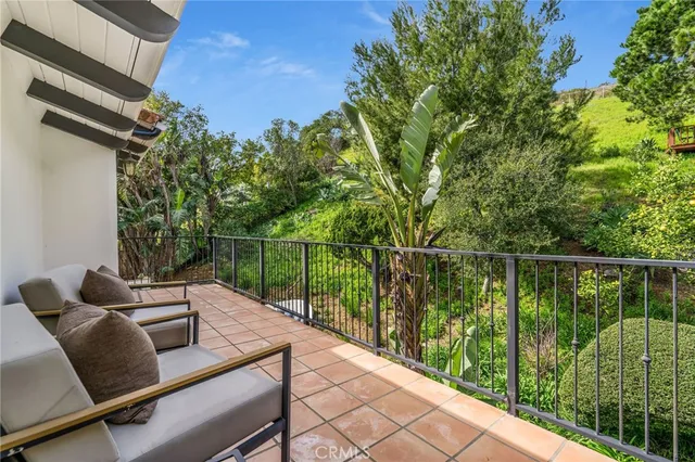 a view of a balcony with potted plants