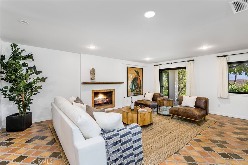 24743 Vantage Point Terrace Malibu, CA 90265 - Photo 44 of 64 a living room with furniture potted plant and a fireplace