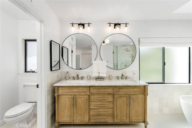 a bathroom with a white bath tub sitting next to a window